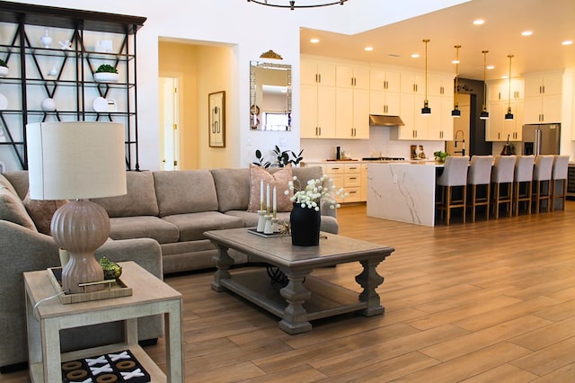 living area with recessed lighting and light wood-style floors