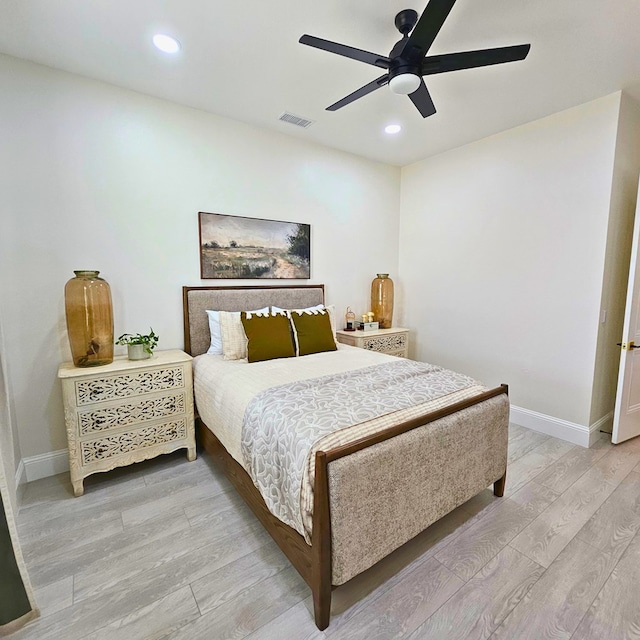 bedroom featuring light wood finished floors, baseboards, visible vents, and recessed lighting