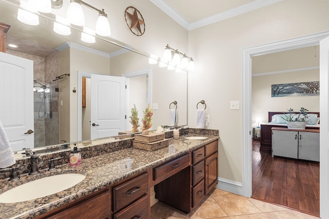 bathroom featuring tile patterned floors, vanity, crown molding, and walk in shower