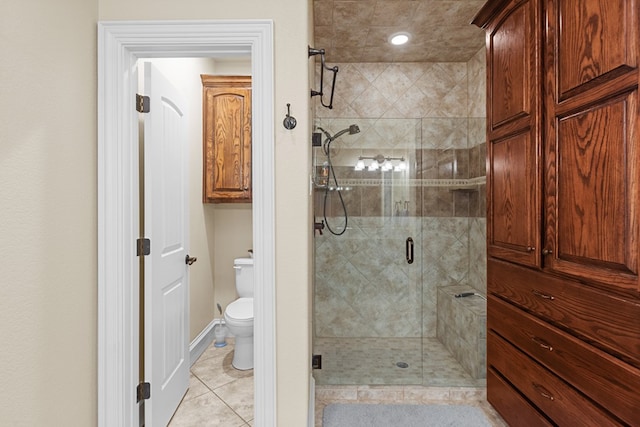 bathroom featuring tile patterned flooring, toilet, and walk in shower