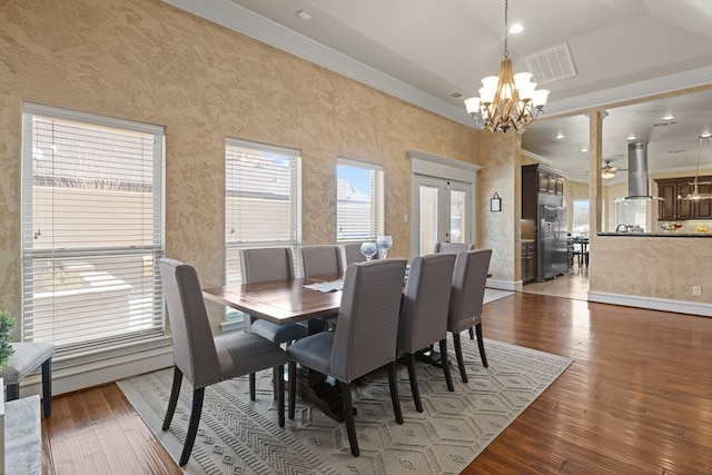 dining room with a chandelier, hardwood / wood-style floors, and ornamental molding