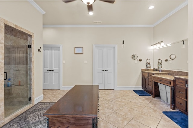 bathroom with tile patterned flooring, a shower with door, ceiling fan, and ornamental molding