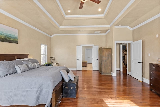 bedroom with wood-type flooring, a towering ceiling, ceiling fan, and ornamental molding