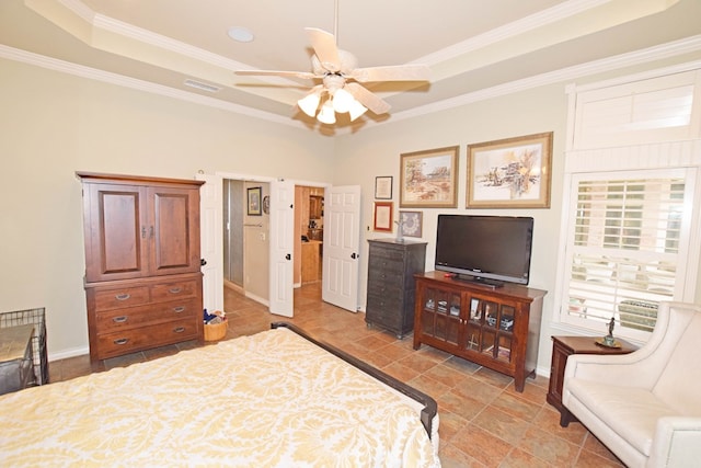 bedroom with ornamental molding and a tray ceiling