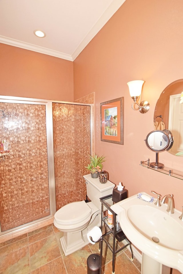 bathroom featuring sink, crown molding, a shower with door, tile patterned flooring, and toilet