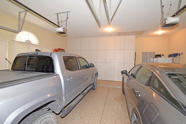 garage with a garage door opener and electric panel