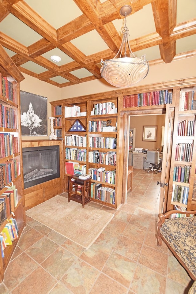 sitting room featuring beamed ceiling and coffered ceiling