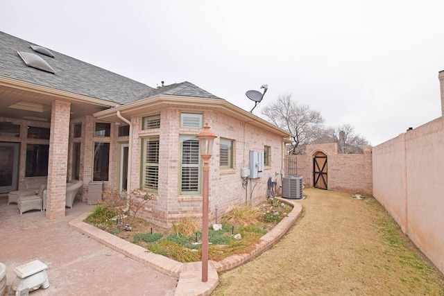 view of home's exterior with central AC unit and a patio area