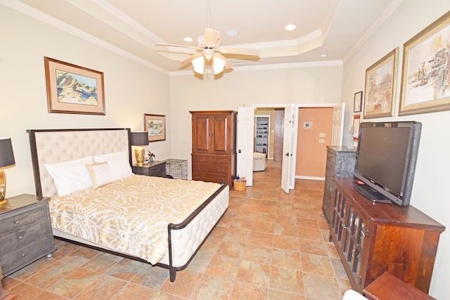 bedroom with crown molding, a tray ceiling, and ceiling fan