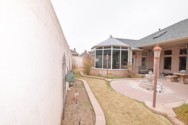 back of house with a patio area and a sunroom