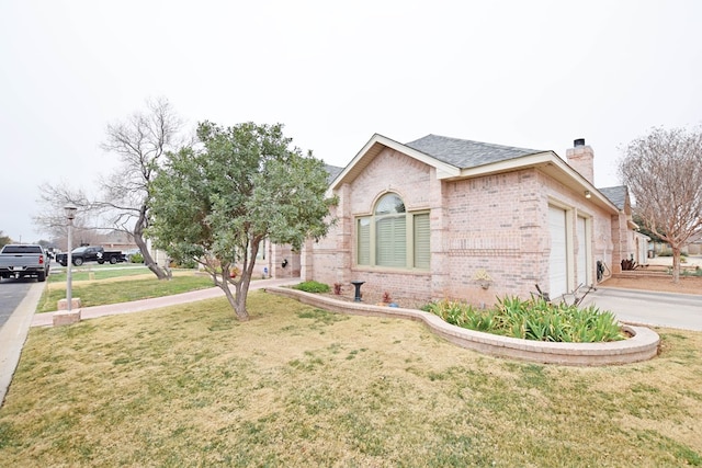 view of property exterior featuring a garage and a lawn