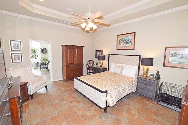 bedroom with ceiling fan, ornamental molding, and a tray ceiling