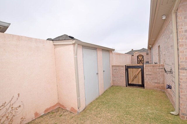 view of outdoor structure featuring a lawn