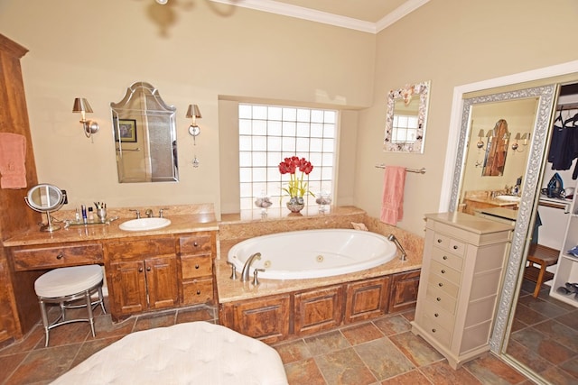 bathroom with ornamental molding, vanity, and a tub