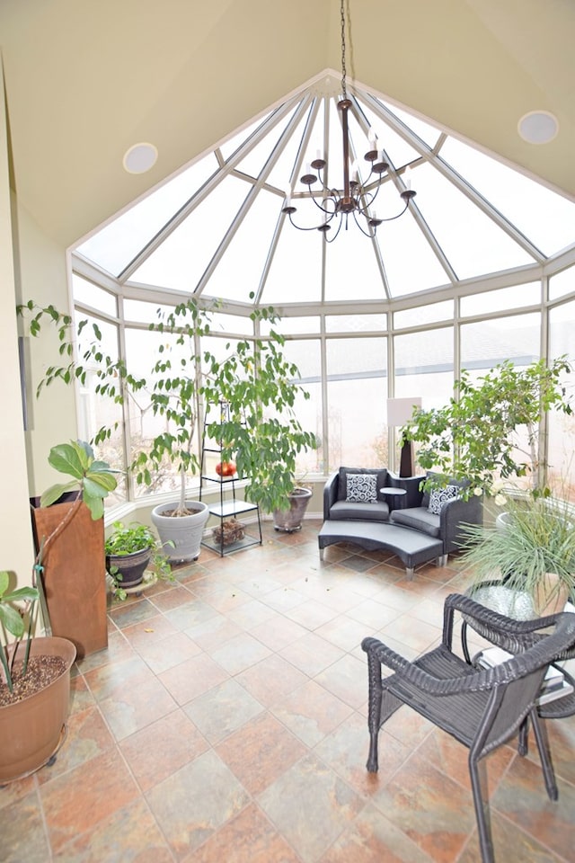 sunroom / solarium featuring a skylight and a notable chandelier