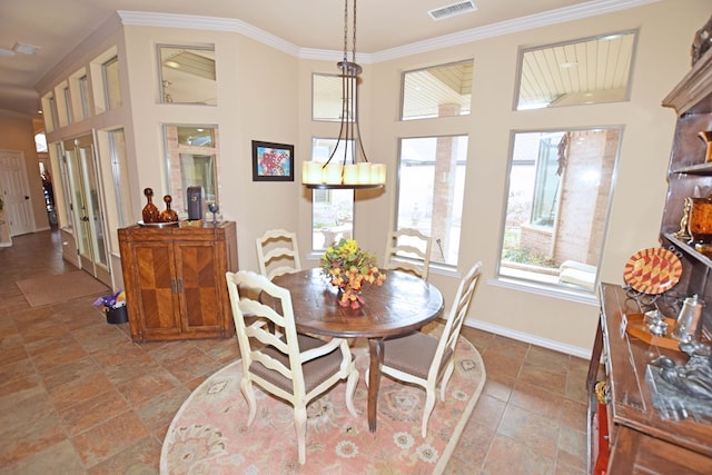 dining area featuring ornamental molding and a towering ceiling