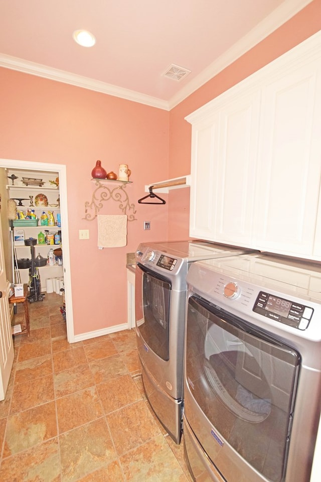 washroom featuring separate washer and dryer, crown molding, and cabinets