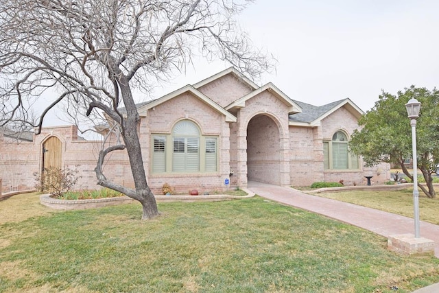 ranch-style home with a front lawn