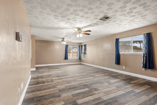 unfurnished room featuring wood-type flooring, a textured ceiling, and ceiling fan