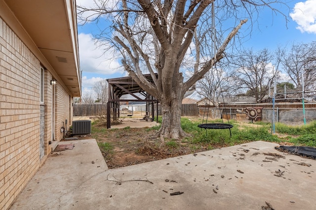 view of yard featuring central AC unit and a patio area