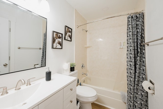 full bathroom with vanity, shower / tub combo, and toilet