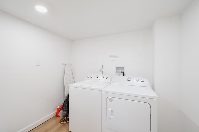 washroom featuring separate washer and dryer and light wood-type flooring