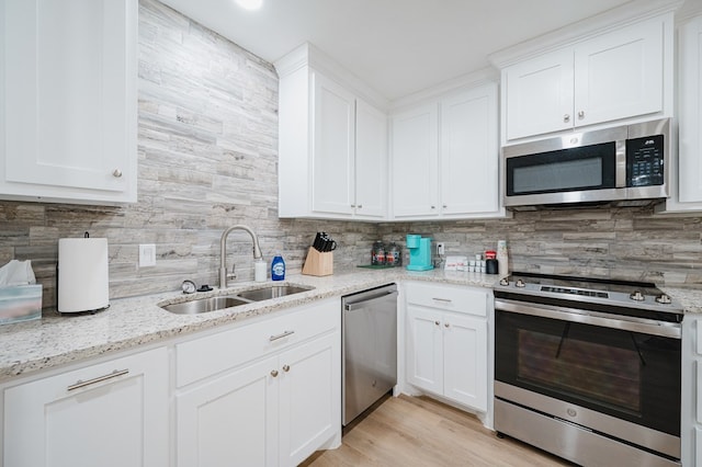 kitchen with sink, white cabinets, and appliances with stainless steel finishes