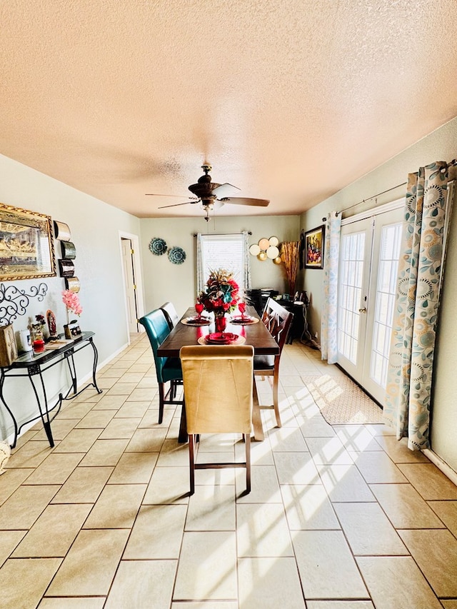 dining area with a textured ceiling, french doors, and ceiling fan