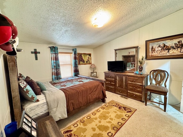 carpeted bedroom with visible vents, a textured ceiling, and vaulted ceiling