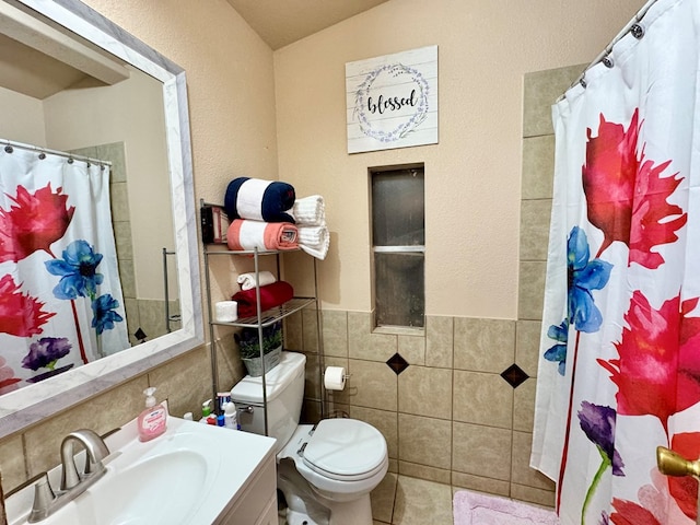 full bath featuring vanity, curtained shower, tile walls, toilet, and tile patterned floors