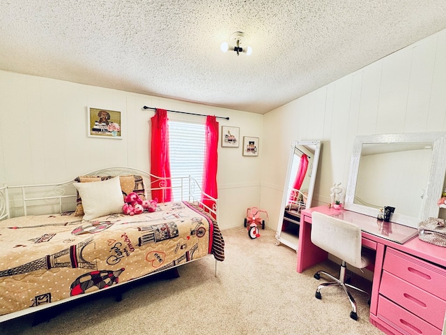 bedroom featuring vaulted ceiling, carpet, built in desk, and a textured ceiling