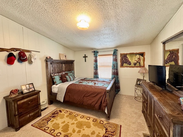 bedroom featuring lofted ceiling, light colored carpet, and a textured ceiling