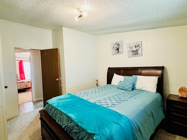 bedroom with carpet flooring and a textured ceiling