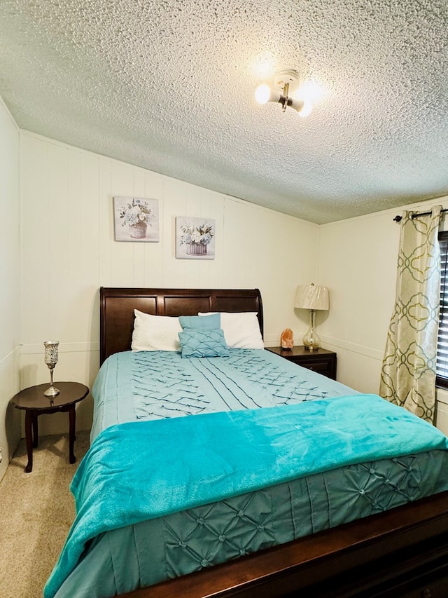 carpeted bedroom with a textured ceiling