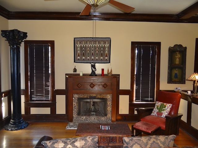 living area featuring hardwood / wood-style flooring, ceiling fan, and crown molding