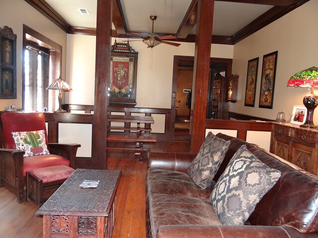 living room featuring ceiling fan, wood-type flooring, and ornamental molding