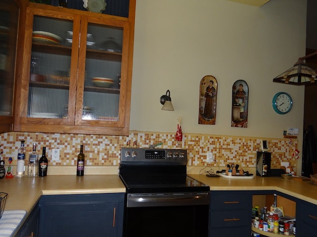 kitchen featuring tasteful backsplash, black range with electric stovetop, and blue cabinetry