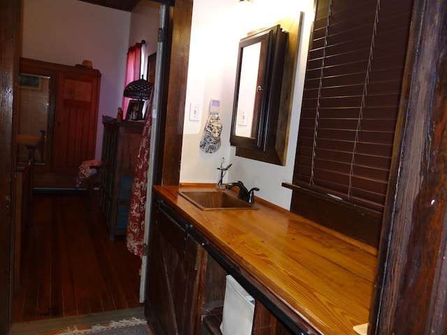 hall with dark hardwood / wood-style floors and sink