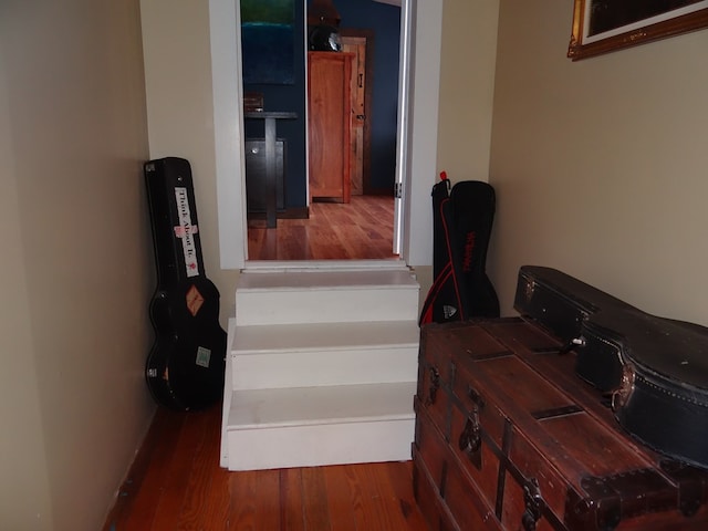 stairway with hardwood / wood-style floors