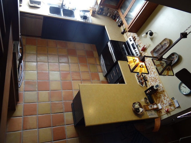 kitchen featuring dishwasher, fridge, and sink