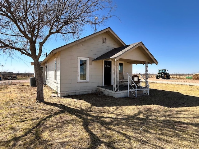 rear view of house featuring cooling unit