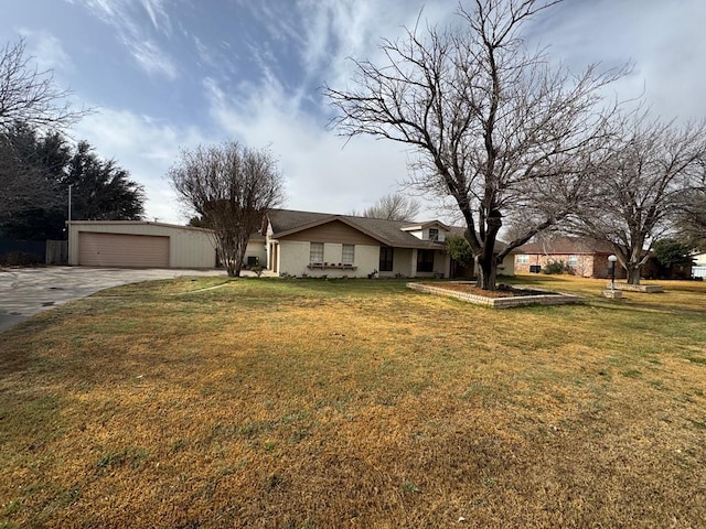 ranch-style house featuring a garage and a front lawn