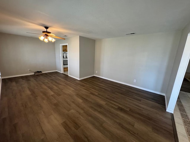 empty room featuring dark hardwood / wood-style flooring and ceiling fan