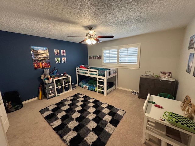 bedroom featuring ceiling fan, carpet floors, and a textured ceiling