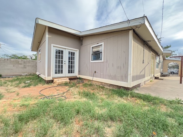 view of side of property with french doors and a patio