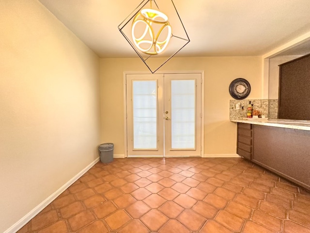 unfurnished dining area featuring french doors