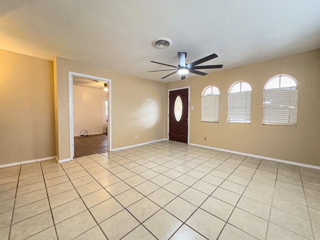 foyer with ceiling fan and light tile patterned flooring