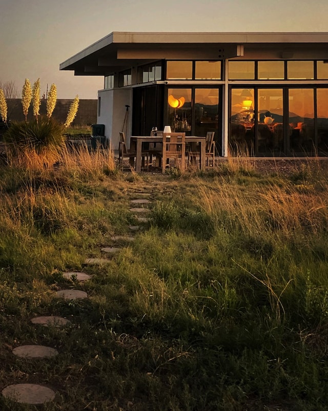 view of back house at dusk