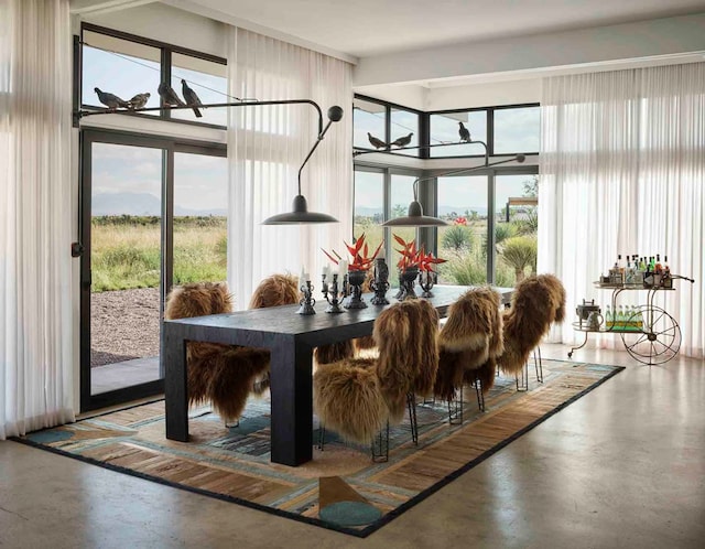 dining space featuring concrete floors