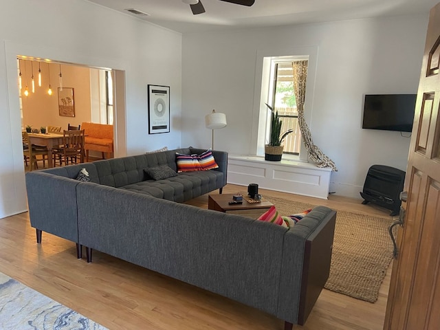 living room with ceiling fan and light hardwood / wood-style floors